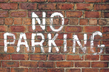 No parking brick wall white spray paint 