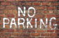 No parking brick wall white spray paint