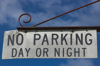 No parking day or night on hanging sign 
