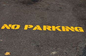 No parking on the ground with yellow painted letters 